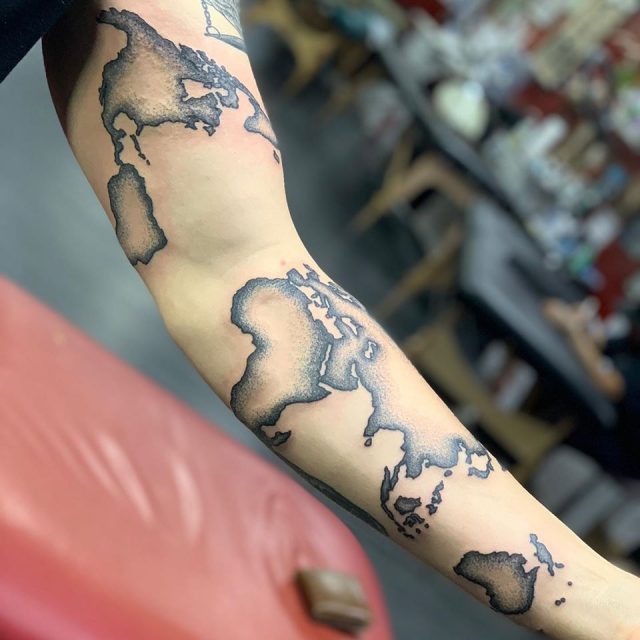 Small world map tattoo on the ankle